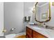 Powder room features hardwood floors, custom vanity with marble countertop and custom mirror at 134 Mellington Ln, Peachtree City, GA 30269