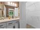 Bathroom vanity with granite counters, a large mirror, and a closet with wire shelving at 134 Mellington Ln, Peachtree City, GA 30269
