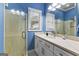Stylish bathroom with blue walls, glass shower, and marble vanity at 134 Mellington Ln, Peachtree City, GA 30269
