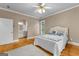Bright bedroom with hardwood floors, ceiling fan, and natural light from window at 134 Mellington Ln, Peachtree City, GA 30269