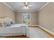Cozy bedroom with hardwood floors, white rug, and a view of the outdoors at 134 Mellington Ln, Peachtree City, GA 30269