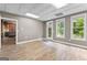 Well-lit bonus room with beautiful wood-look floors, a door to the outside, and natural lighting at 134 Mellington Ln, Peachtree City, GA 30269