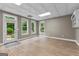 Spacious bonus room with wood floors, three windows, and access to a patio at 134 Mellington Ln, Peachtree City, GA 30269