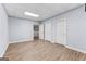 The finished room features a door to the hall and two additional doors, with wood-look flooring at 134 Mellington Ln, Peachtree City, GA 30269