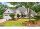 Charming single Gathering home with a well-manicured lawn, brick path, and three car garage at 134 Mellington Ln, Peachtree City, GA 30269