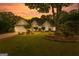 Beautiful home at sunset featuring manicured landscaping and warm exterior lighting at 134 Mellington Ln, Peachtree City, GA 30269