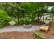 Outdoor fire pit area with lush landscaping, perfect for gatherings and relaxation at 134 Mellington Ln, Peachtree City, GA 30269