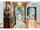 View of a well-lit foyer with hardwood floors, decor and view of the front lawn at 134 Mellington Ln, Peachtree City, GA 30269