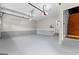 Spacious and clean garage with painted floor and a door to the main house at 134 Mellington Ln, Peachtree City, GA 30269