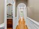 Hallway featuring hardwood floors with archway to powder room and other rooms at 134 Mellington Ln, Peachtree City, GA 30269