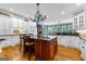Spacious kitchen with a large central island, dark countertops, and modern appliances at 134 Mellington Ln, Peachtree City, GA 30269