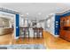 Open kitchen boasts white cabinetry, hardwood floors, and an island with bar stool seating at 134 Mellington Ln, Peachtree City, GA 30269