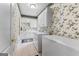 Laundry room with floral wallpaper, cabinets, washer, dryer, and extra freezer at 134 Mellington Ln, Peachtree City, GA 30269
