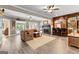 Open-concept living room with fireplace, wet bar, and view to outdoor pool area at 134 Mellington Ln, Peachtree City, GA 30269