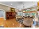 Elegant living room with hardwood floors, a fireplace, and large windows providing plenty of natural light at 134 Mellington Ln, Peachtree City, GA 30269