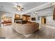 Spacious living room with fireplace, wood floors, and open bar area, perfect for entertaining guests at 134 Mellington Ln, Peachtree City, GA 30269