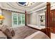 Main bedroom features king bed, side tables, windows and ensuite bathroom at 134 Mellington Ln, Peachtree City, GA 30269