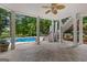Covered patio featuring concrete flooring, white columns, and stairs to pool area at 134 Mellington Ln, Peachtree City, GA 30269
