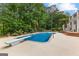 Backyard with in-ground pool, diving board, and lush, mature landscaping at 134 Mellington Ln, Peachtree City, GA 30269