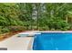 In-ground pool with diving board, set in a private backyard setting with mature trees at 134 Mellington Ln, Peachtree City, GA 30269