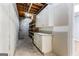 Unfinished storage room with shelving, a workbench, and visible pipes and rafters at 134 Mellington Ln, Peachtree City, GA 30269