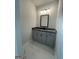 Bathroom featuring a gray vanity cabinet, a black countertop, and marble floors at 149 Silvercrest Dr # 58, Acworth, GA 30101
