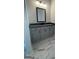 Bathroom vanity with gray cabinets, a dark countertop, a large mirror, and marble floors at 149 Silvercrest Dr # 58, Acworth, GA 30101