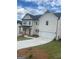 Two-story home with white siding, covered front porch, and a two-car garage with a long driveway at 149 Silvercrest Dr # 58, Acworth, GA 30101