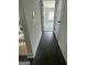 Hallway with dark wood floors leading to a bedroom with gray carpet at 149 Silvercrest Dr # 58, Acworth, GA 30101
