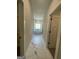Hallway leading to a bathroom with a white, free-standing tub by a window, and marble floors at 149 Silvercrest Dr # 58, Acworth, GA 30101