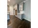 Gray kitchen cabinets with stainless steel appliances, white countertop, and hardwood floors at 149 Silvercrest Dr # 58, Acworth, GA 30101
