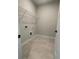 Laundry room with tile floor, washer and dryer hookups, and wire shelving at 149 Silvercrest Dr # 58, Acworth, GA 30101