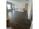 Open living room with dark hardwood floors and staircase with black metal railing at 149 Silvercrest Dr # 58, Acworth, GA 30101