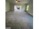 Spacious living room with gray carpet and windows offering natural light at 149 Silvercrest Dr # 58, Acworth, GA 30101