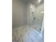 Bathroom featuring a glass-enclosed shower with marble tiling, and a shower niche at 149 Silvercrest Dr # 58, Acworth, GA 30101