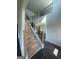 A staircase features wood steps, black iron spindles, and natural light at 149 Silvercrest Dr # 58, Acworth, GA 30101
