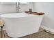 Relaxing white soaking tub with wooden tray offers a luxurious bath experience, complemented by a modern faucet at 95 Jacoby Dr # 103, Fairburn, GA 30213