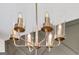 Elegant chandelier with clear glass shades and brass-toned hardware provides warm and stylish lighting at 95 Jacoby Dr # 103, Fairburn, GA 30213