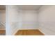 Empty walk in closet with white wire shelving and carpeted floor at 95 Jacoby Dr # 103, Fairburn, GA 30213