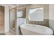 Bathroom featuring a glass enclosed shower and soaking tub at 112 Felicity Pike, Locust Grove, GA 30248