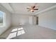 Large bedroom features tray ceilings, ceiling fan, and large windows allowing for lots of natural light at 112 Felicity Pike, Locust Grove, GA 30248