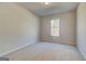 Cozy bedroom with neutral carpet and a bright window at 112 Felicity Pike, Locust Grove, GA 30248
