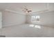 Large bedroom features tray ceilings, ceiling fan, and large windows allowing for lots of natural light at 112 Felicity Pike, Locust Grove, GA 30248