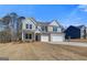 Attractive two-story house with a three-car garage and beautifully landscaped front yard at 112 Felicity Pike, Locust Grove, GA 30248