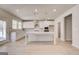 Bright kitchen features a large center island, white cabinets, and stainless appliances at 112 Felicity Pike, Locust Grove, GA 30248