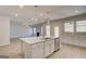 Spacious living room area with kitchen island, fireplace, and plenty of natural light at 112 Felicity Pike, Locust Grove, GA 30248