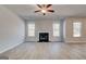 Bright living room with a cozy fireplace and modern flooring at 112 Felicity Pike, Locust Grove, GA 30248