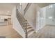 Elegant staircase with wrought iron railings and hardwood steps at 112 Felicity Pike, Locust Grove, GA 30248