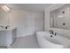Modern bathroom featuring a soaking tub, tiled floors, and vanity with sink at 120 Felicity Pike, Locust Grove, GA 30248