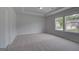 Bright bedroom with neutral carpet, double windows, and a closet at 120 Felicity Pike, Locust Grove, GA 30248